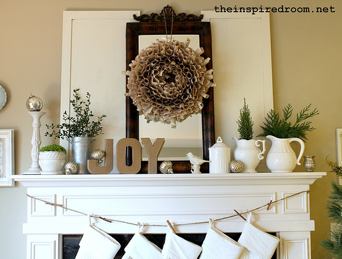 neutral christmas mantel white pottery book page wreath joy