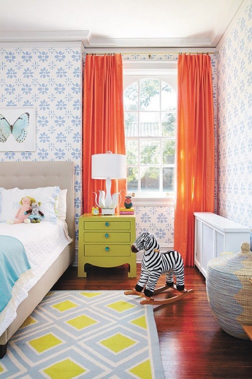 Colorful childrens bedroom with orange curtains