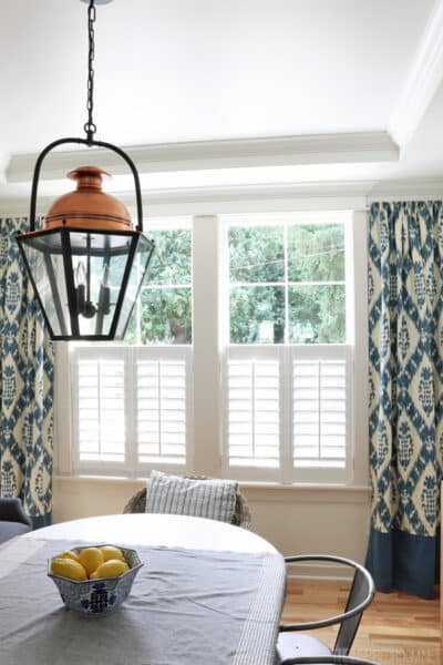 The Inspired Room Dining Room - Copper Lantern Plantation Shutters and Ikat Curtains