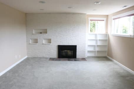 Basement Before - White Fireplace