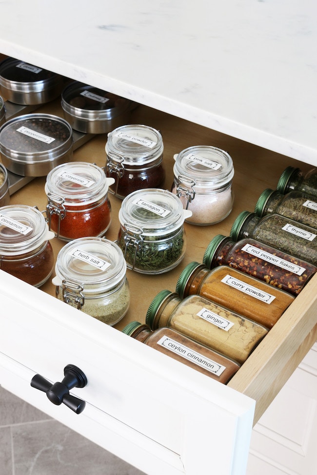 Convenient Spice Drawer Organization with Glass Jars and Labels