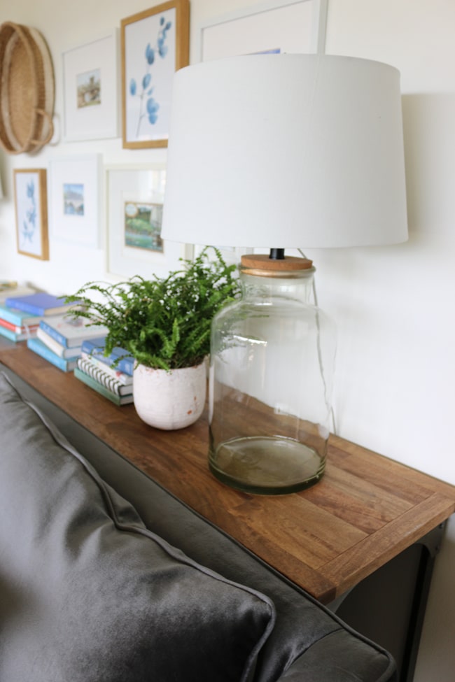 Table behind couch store against wall