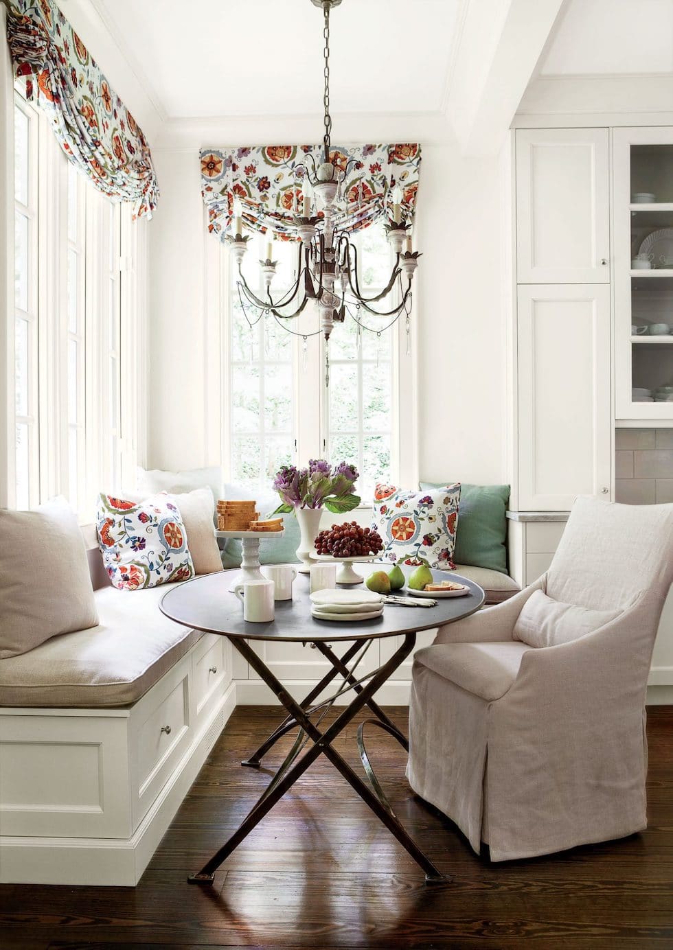A Classic White Kitchen with Colorful Patterned Roman Shades