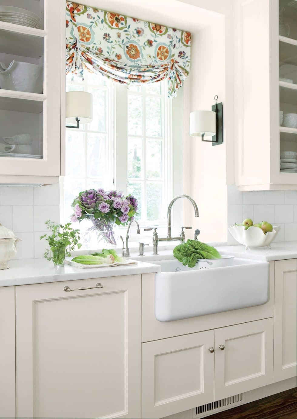 A Classic White Kitchen with Colorful Patterned Roman Shades