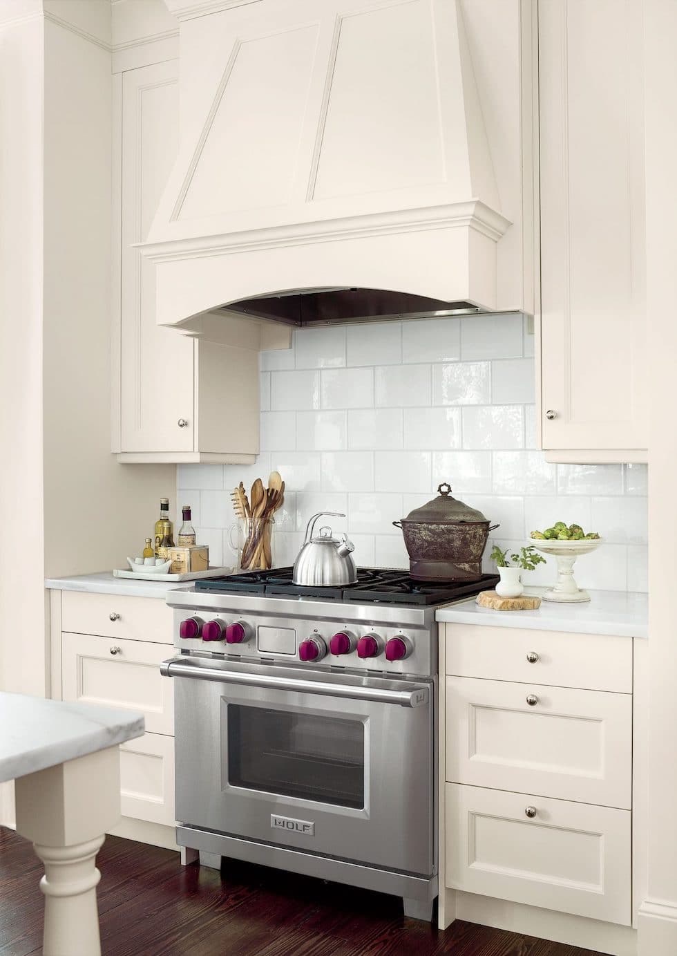 A Classic White Kitchen with Colorful Patterned Roman Shades