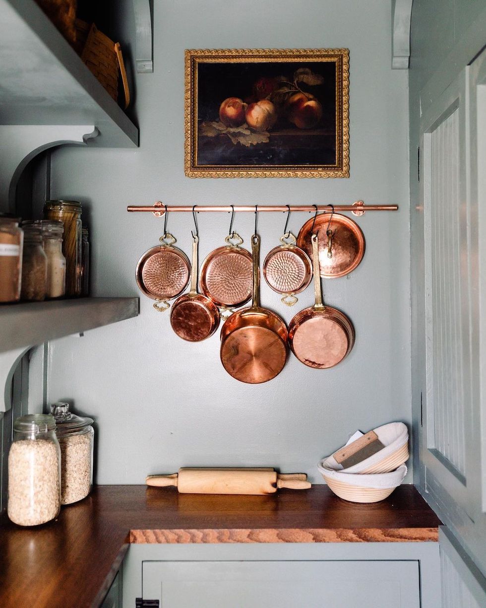 https://theinspiredroom.net/wp-content/uploads/2023/01/small-butlers-pantry-hook-rack-copper-pots-shelves-jars-wood-countertop-small-space.jpg