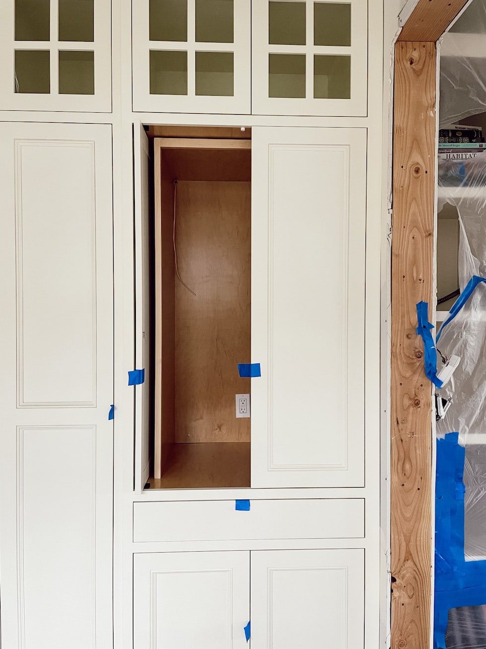 https://theinspiredroom.net/wp-content/uploads/2023/04/coffee-station-pocket-door-cabinet-glass-upper-cabinets-the-inspired-room-remodel-progress.jpg