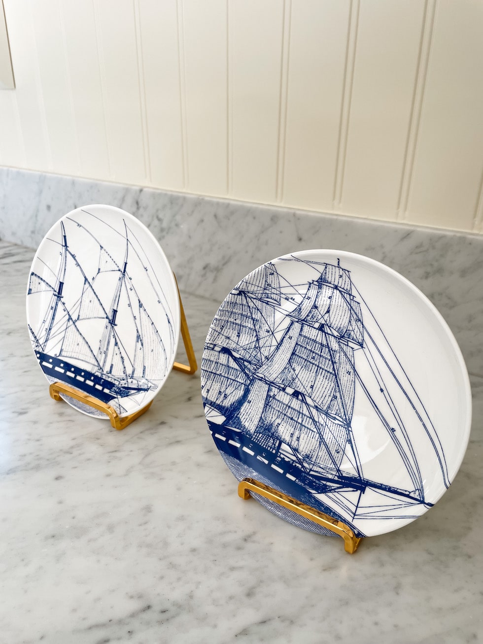 https://theinspiredroom.net/wp-content/uploads/2023/06/gold-easel-stands-sailboat-plates-art-the-inspired-room-1.jpg