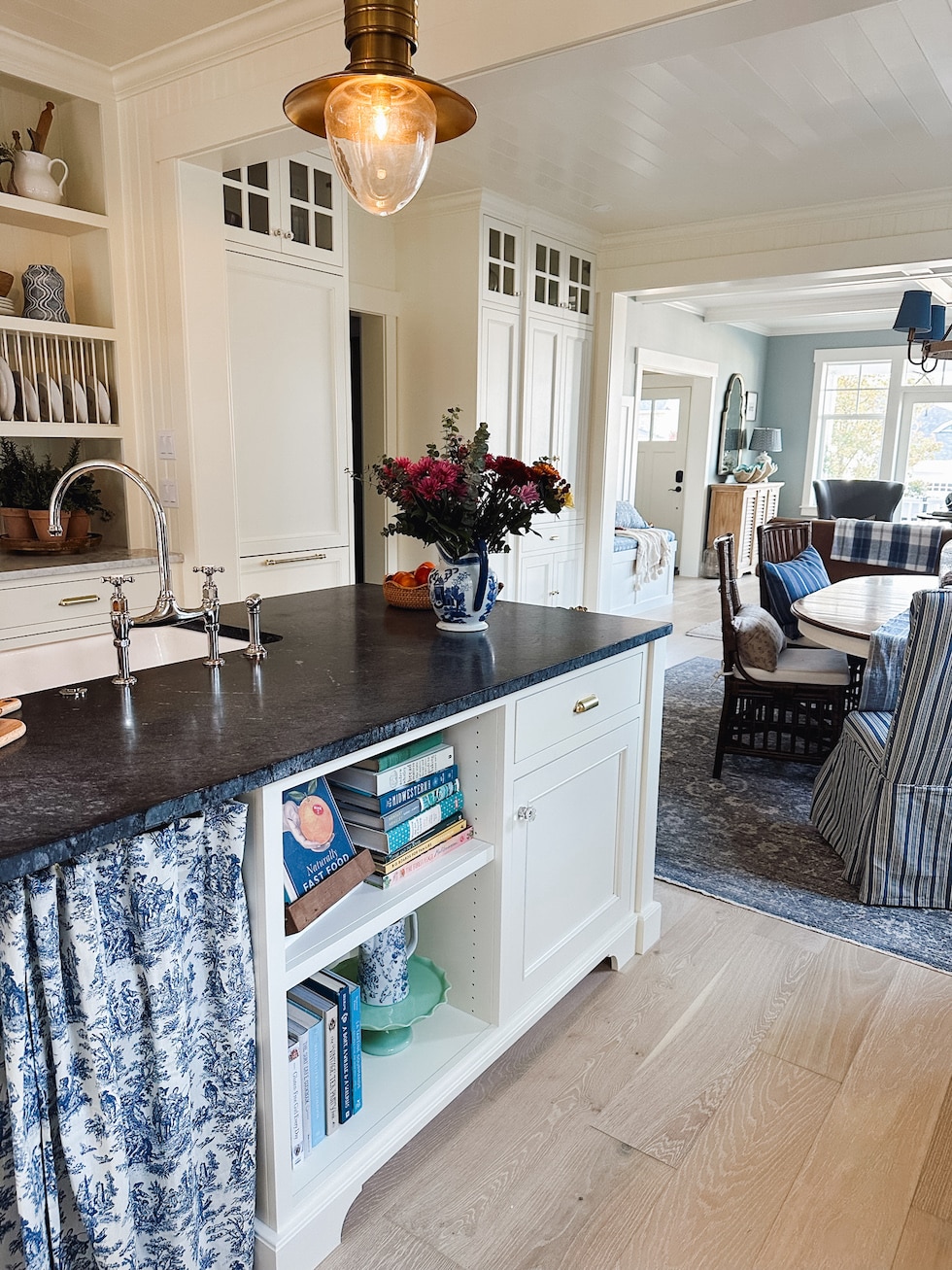 coastal cottage kitchen soapstone counters glass cabinets open bookshelves island wood floors the inspired room