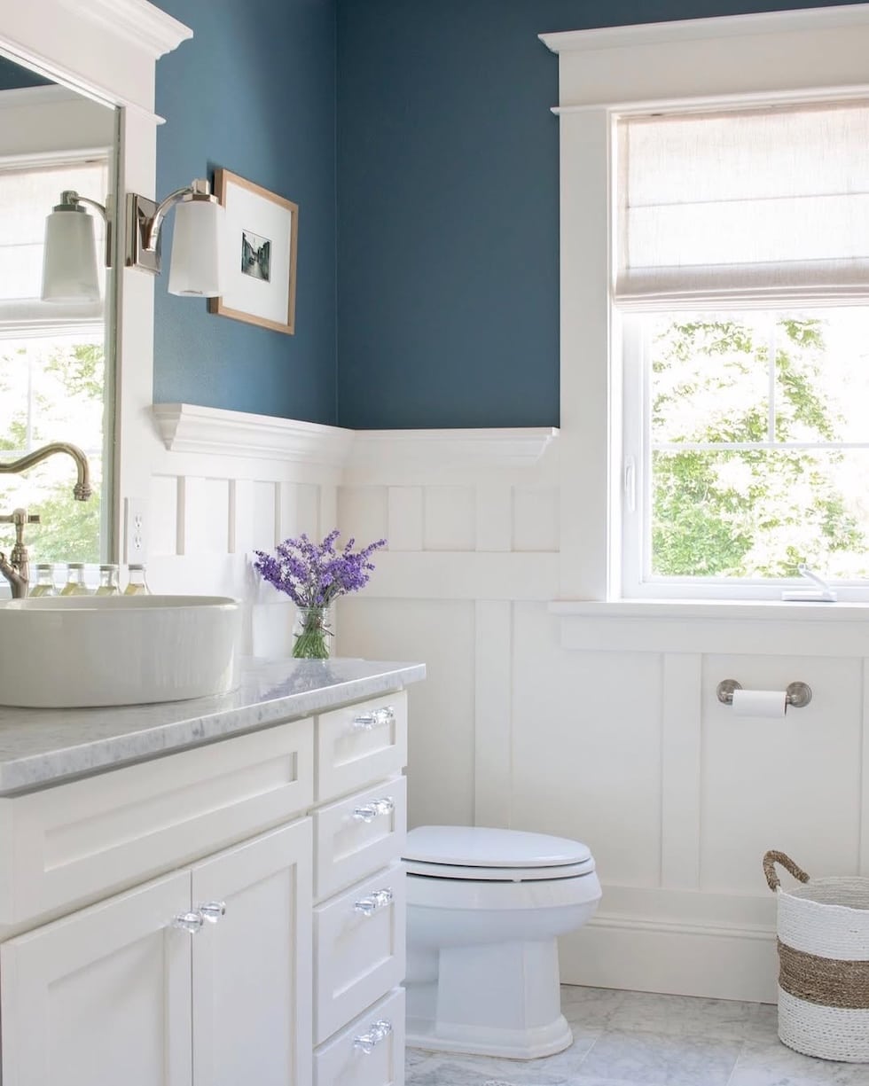 blue walls bathroom white vanity marble counters