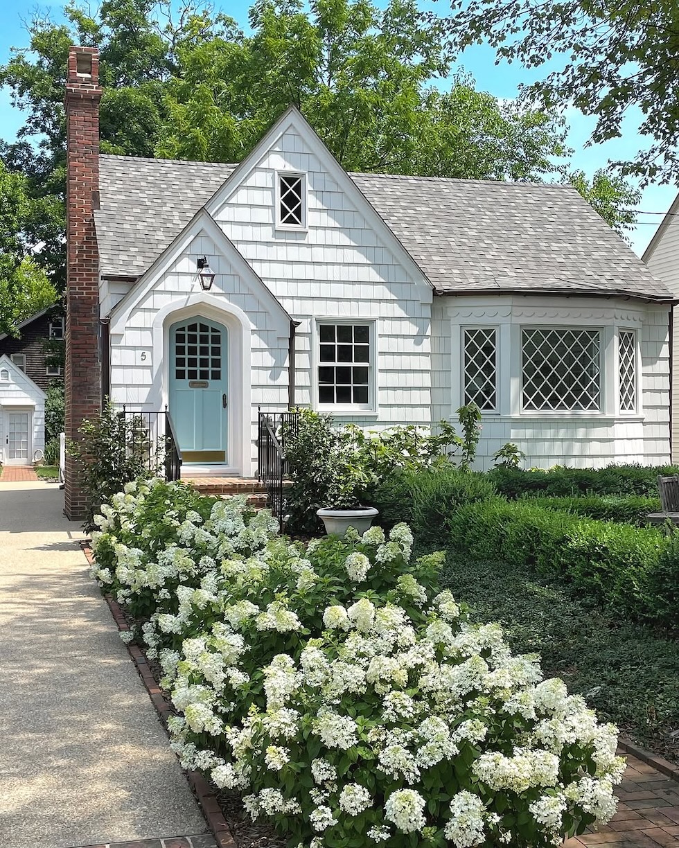 charming white house blue door spring hydrangeas loi thai